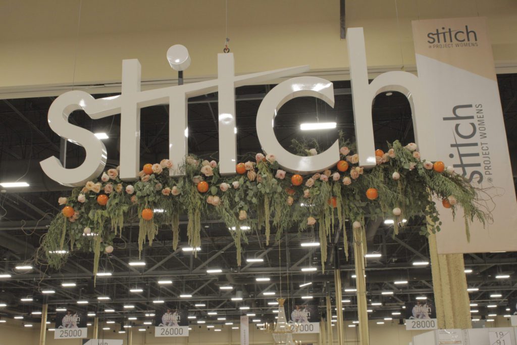 Floral design at Stitch trade show booth.