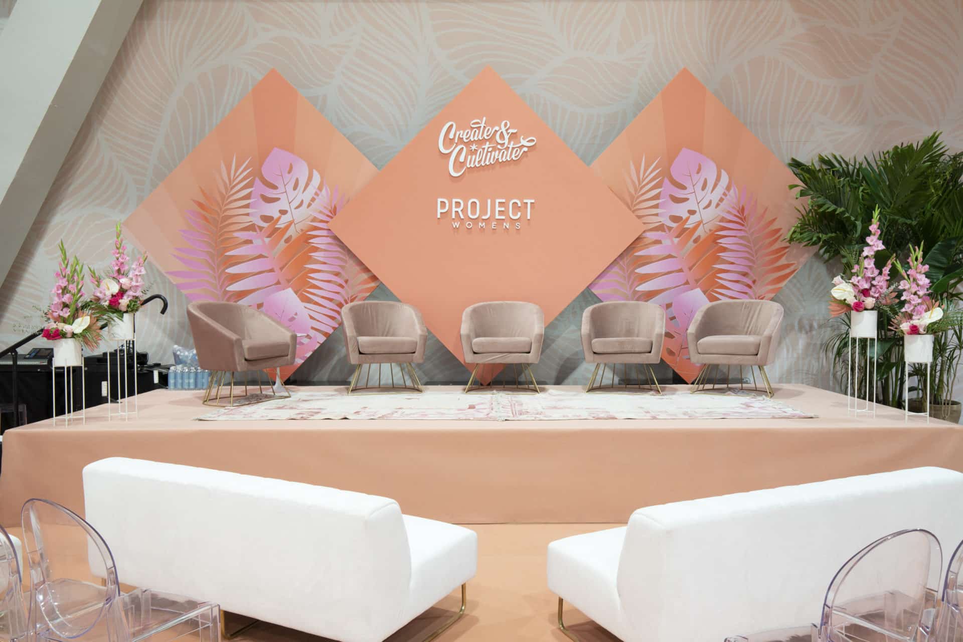 Plant rental with stands surrounding a presentation platform.